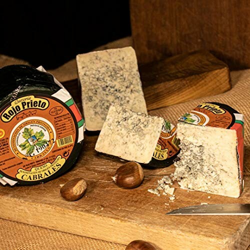 Cabrales cheese beautifully presented on a wooden board with nuts.