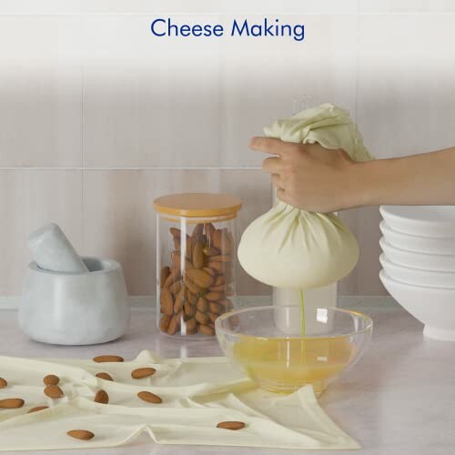 Person squeezing cheesecloth over bowl, almonds and kitchen items nearby