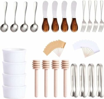 Assorted kitchen serving utensils including spoons, forks, butter knives, ramekins, honey dippers, and cheese markers.