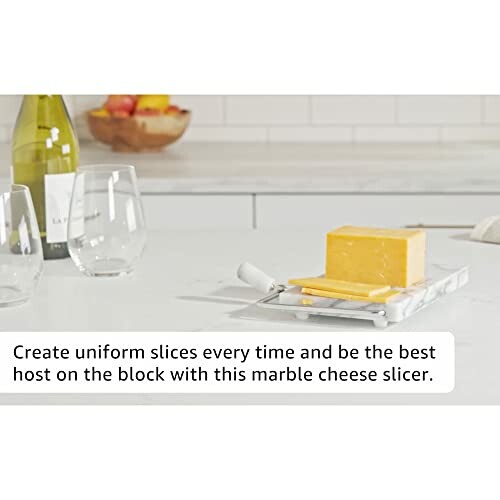 Marble cheese slicer with block of cheese on kitchen counter.