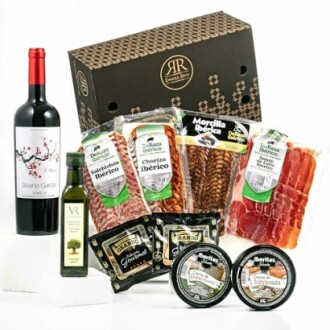 Spanish gourmet hamper with wine, olive oil, and cured meats.