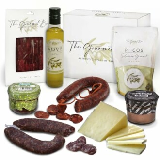 A selection of Spanish gourmet tapas including sausage, cheese, olive oil, and snacks.