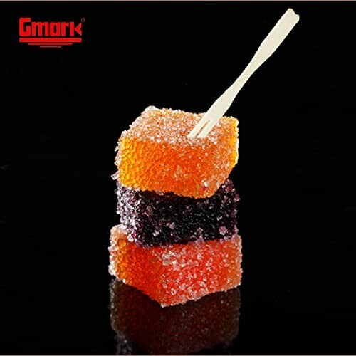 Stack of sugar-coated gummy cubes with a toothpick